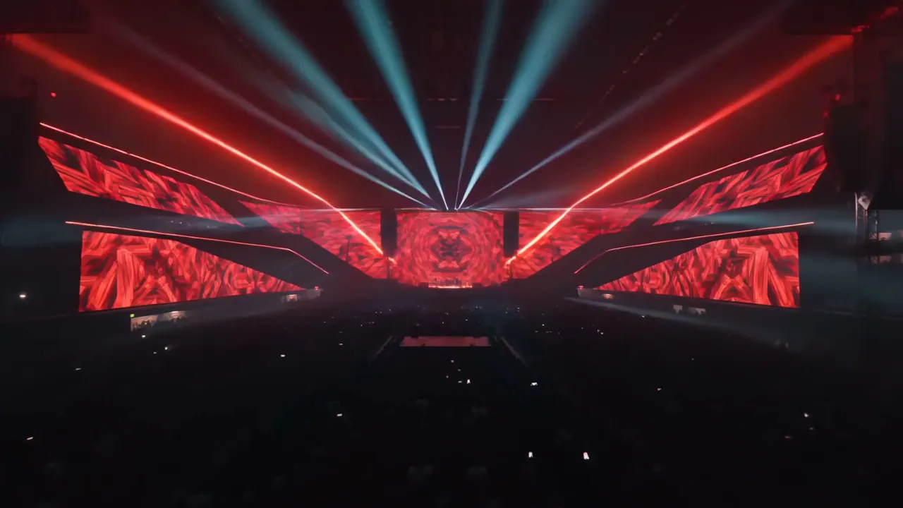 Red laser lines and white beams over a kaleidoscopic LED stage